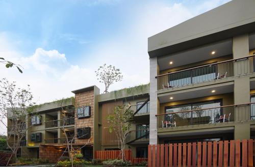 an apartment building with balconies and a fence at Gategaa Village in Chiang Mai