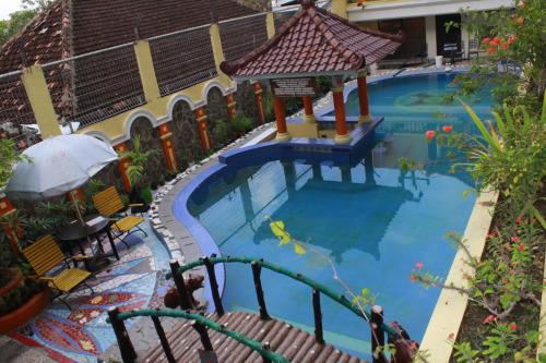 a large swimming pool with a gazebo at Mega Bintang Sweet Hotel 2 in Cepu