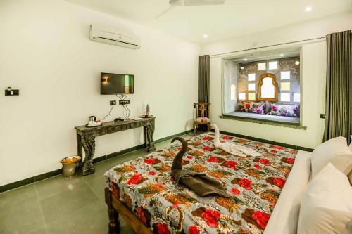 a bedroom with a bed with a bag on it at The Neem Tree in Udaipur