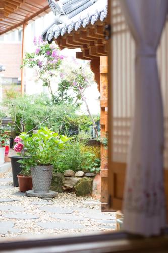 an outdoor patio with plants and a stone walkway at Starlight Rest Area in Jeonju