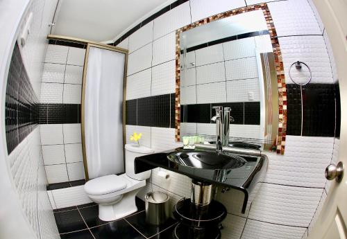 a small bathroom with a sink and a toilet at Yakana Hotel in San Pedro de Atacama
