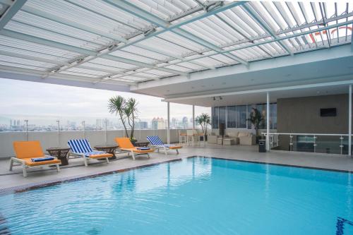 a swimming pool on the roof of a building at Grand G7 Hotel Kemayoran in Jakarta