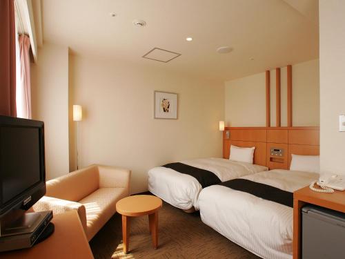 Säng eller sängar i ett rum på Hotel New Gaea Omuta Garden