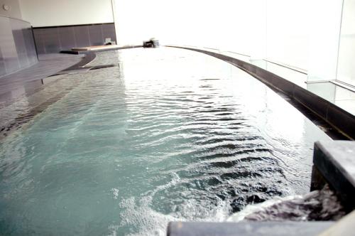 a large pool of water in a building at Hotel Kyocera in Kirishima