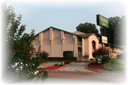 a building with a sign on the side of a street at West Bank Inn in Augusta