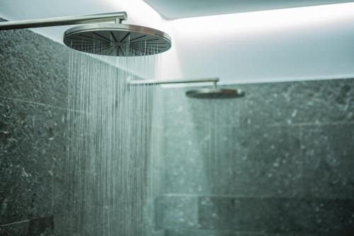 a bathroom with a shower with a shower head at Nyborg Strand Hotel & Konference in Nyborg