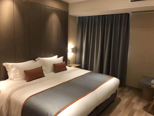 a bedroom with a large bed in a hotel room at SHANGHAI-DECO Hotel-Free shuttle bus to Pudong Airport and Disneyland in Shanghai