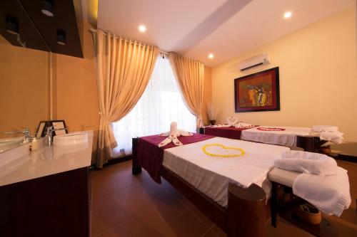 a hotel room with two beds and a sink at Seahorse Resort & Spa in Mui Ne