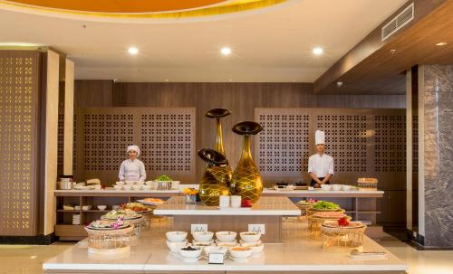 a buffet line with food on display in a restaurant at Muong Thanh Luxury Vientiane Hotel in Vientiane