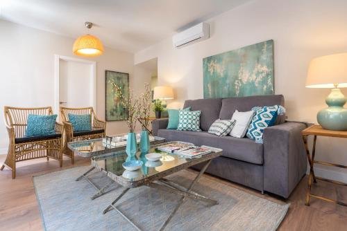 a living room with a couch and a table at Genteel Home Picasso in Málaga