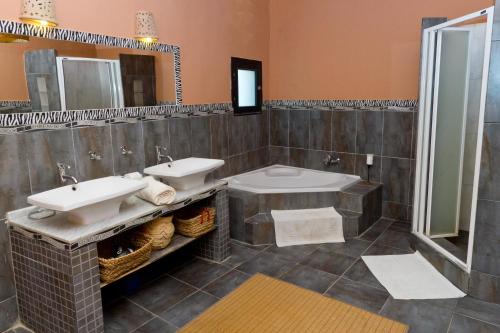 a bathroom with two sinks and a shower at Blue Beach Club Apartment in Dahab