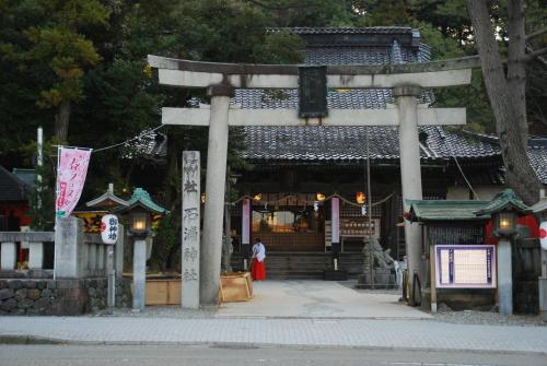 a person standing in front of a temple at Town Hotel 41 in Kanazawa