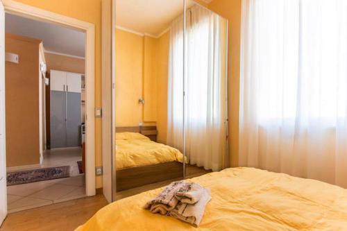 a bedroom with a mirror and two beds in it at Bomboniera fronte mare ! in Viareggio