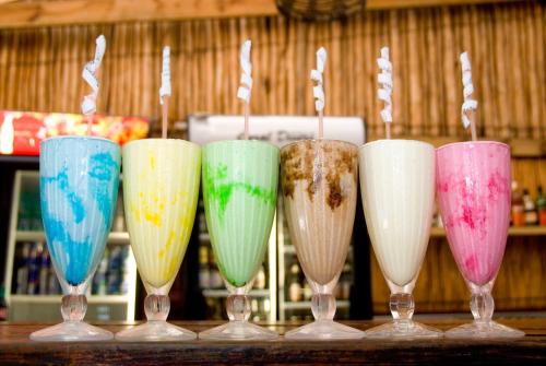 a row of different colored wine glasses on a table at Coral Divers in Sodwana Bay