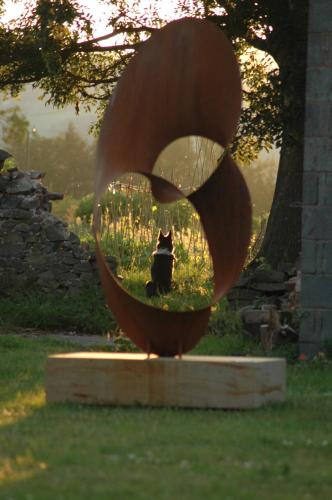 a statue of a cat sitting in a flower pot at Mid Wales Arts B&B in Caersws