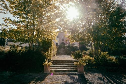 a set of stairs leading up to a house with the sun at L'Orto Di Panza in Abbadia di Montepulciano