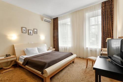 Postel nebo postele na pokoji v ubytování Residence Odesskij Dvorik