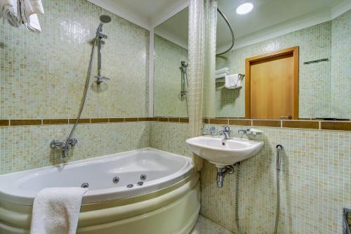 a bathroom with a sink and a bath tub at Polikoff in Saint Petersburg