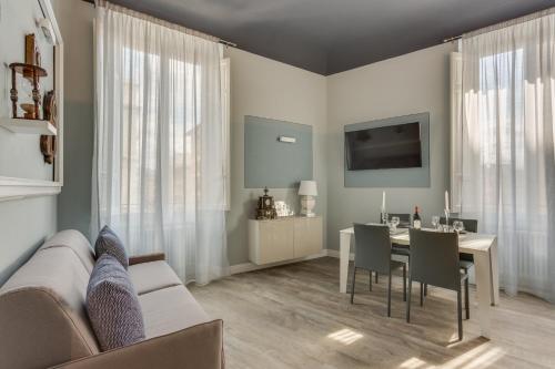a living room with a couch and a table at Cherubini Palace Thematic Apartment in Florence