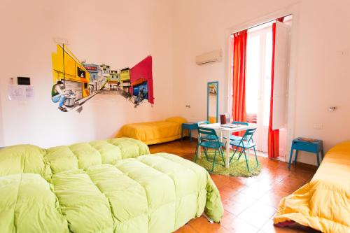 a room with a bed, a desk, and a painting on the wall at A Casa di Amici in Palermo