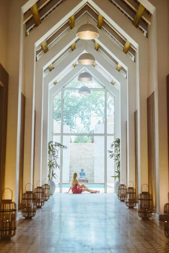a little girl sitting on the floor in a large room at LUX* Grand Gaube Resort & Villas in Grand Gaube