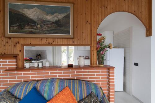 a kitchen with a brick fireplace with a refrigerator at Villa Bianca in Varenna