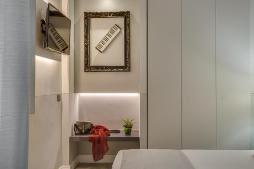 a room with a bed and a mirror on the wall at Cherubini Palace Thematic Apartment in Florence