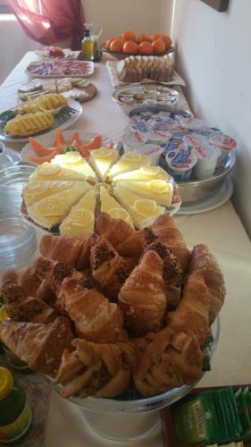 a table with a bunch of different types of pastries at Hotel Villa Lauri in Neive