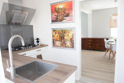 a kitchen with a sink and a counter top at kustappartementenkatwijk in Katwijk aan Zee