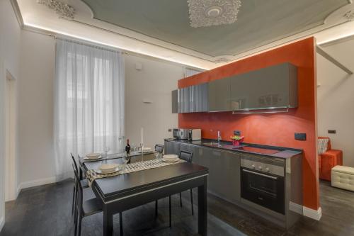 a kitchen with a table and a counter top at Cherubini Palace Thematic Apartment in Florence