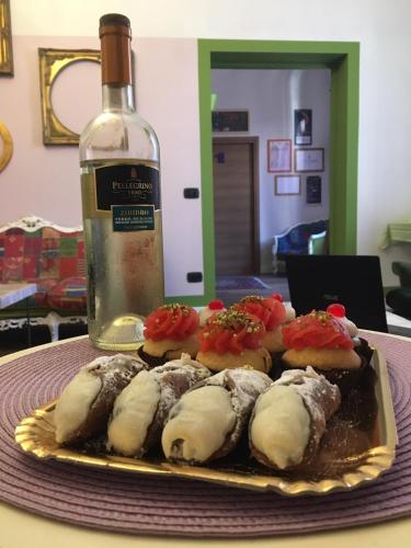 a plate of sushi and a bottle of wine at Cialoma B&B in Palermo