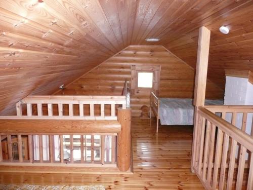 a log cabin with a bedroom and a bunk bed at Vuorenhelmi in Rutalahti