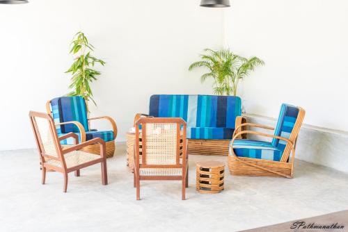 a group of chairs and wicker chairs in a room at South House-Weligama in Weligama