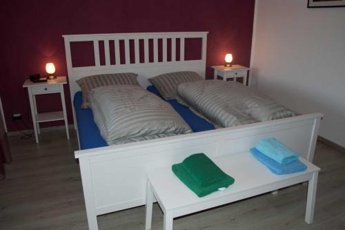 a bedroom with two beds with towels on a table at Ferienhaus Zur Edertalsperre in Edersee
