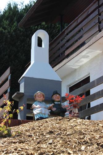 two dolls sitting on top of a house at Ferienhaus Zur Edertalsperre in Edersee
