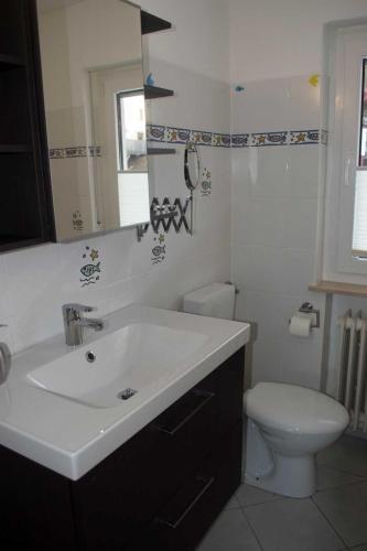a bathroom with a white sink and a toilet at Ferienhaus Zur Edertalsperre in Edersee