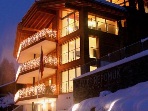 a building with christmas lights on the side of it at Chalet Nepomuk in Zermatt