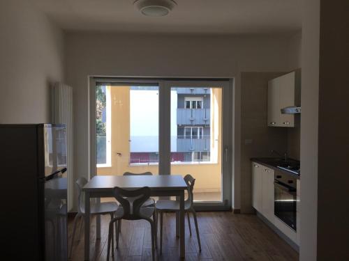 a kitchen with a table and chairs and a window at Residence al Pino in Matera