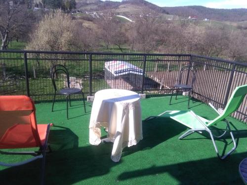 a patio with chairs and a table and a playground at Vila la Izvorul Putinei in Haţeg