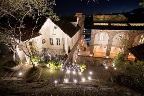 a building with lights in front of it at night at Hotel de Piedra in Bernal
