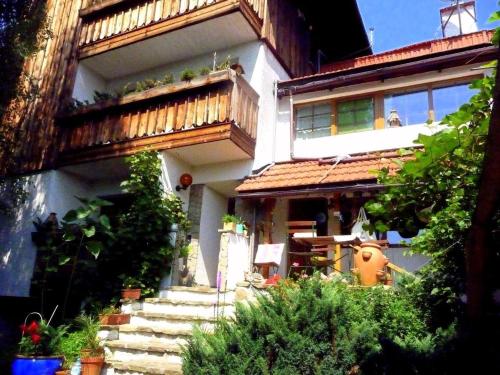 a house with stairs and a balcony on it at Farma Zdrowia in Znamirowice
