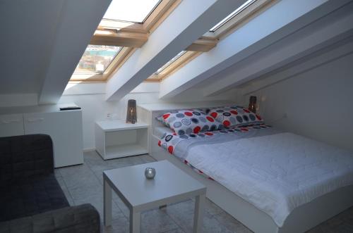 a bedroom with a bed and a table at Apartments Mare I in Baška