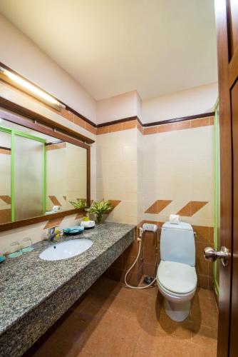 a bathroom with a toilet and a sink at Lazi Beach Resort in Lagi