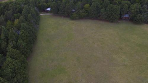an aerial view of a large grass field with a house at Estancia Laguna Vitel in Chascomús