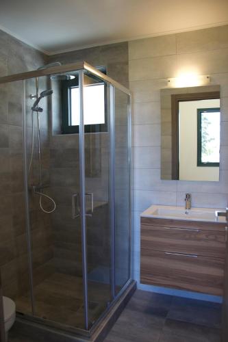a bathroom with a shower and a sink at Angelbay Bungalows in Agia Triada