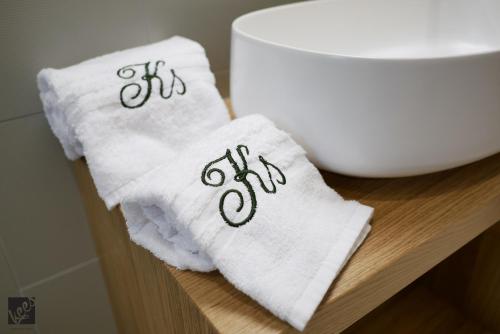 a pair of towels with the numbers eighty eighty on them at Kees Apulian Stay in Monopoli