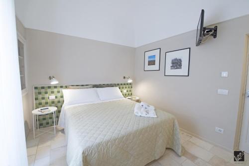 a bedroom with a bed with a white bedspread at Kees Apulian Stay in Monopoli