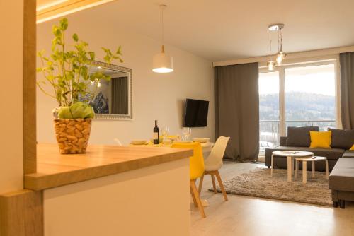 a kitchen and living room with a yellow counter top at Apartament Na Urlop - Wisła Kamienna - Apartamenty z widokiem na panoramę Wisły in Wisła