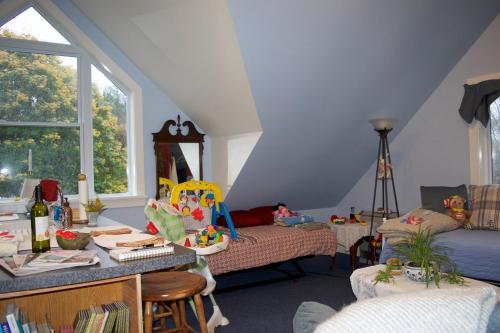 a attic room with a table and a bed at Artful Lodging & Retreats in Montpelier