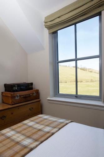 a bedroom with a bed and a window at Blairmore Farm in Crieff